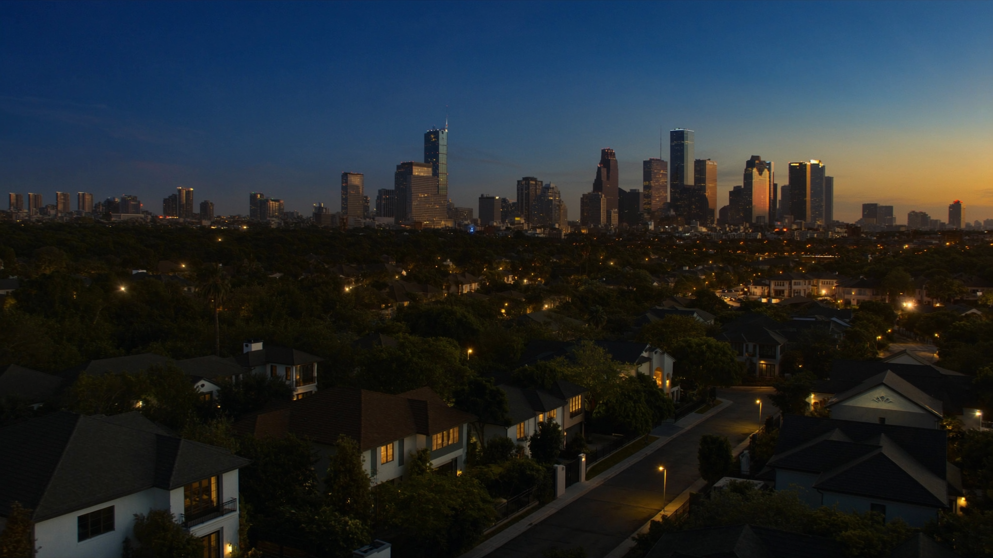 Houston evening skyline above elegant residential streets with warm home lights